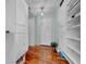 Walk in closet with custom shelving and a view of the wooden floors at 940 Monte Cristo Blvd, Tierra Verde, FL 33715