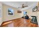 Bright exercise room features hardwood floors, ceiling fan, and workout equipment by the window at 940 Monte Cristo Blvd, Tierra Verde, FL 33715