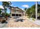 Elegant two-story home with a brick driveway, multi-car garage, balconies and lush landscaping at 940 Monte Cristo Blvd, Tierra Verde, FL 33715