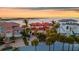 Elegant waterfront home boasting a red tile roof, multiple balconies, and manicured palm trees at 940 Monte Cristo Blvd, Tierra Verde, FL 33715