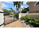 Ornate gate leading to the property, surrounded by lush landscaping and a brick paver driveway at 940 Monte Cristo Blvd, Tierra Verde, FL 33715