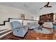 Open living area with hardwood floors, comfortable seating, and stylish built-in shelving at 940 Monte Cristo Blvd, Tierra Verde, FL 33715