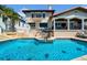 Beautiful backyard pool with an outdoor kitchen area, perfect for entertaining and relaxing at 940 Monte Cristo Blvd, Tierra Verde, FL 33715