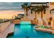 Inviting pool and spa with travertine tile, and lush landscaping creates an oasis for relaxation and entertaining at 940 Monte Cristo Blvd, Tierra Verde, FL 33715