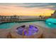 Luxurious pool and spa with waterfront views, illuminated steps, and elegant stone detailing at 940 Monte Cristo Blvd, Tierra Verde, FL 33715