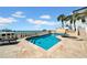 Inviting pool and spa with travertine tile, water views, and lush landscaping create an oasis at 940 Monte Cristo Blvd, Tierra Verde, FL 33715