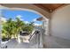 Expansive front porch with palm tree views and white railings creates a welcoming outdoor space at 940 Monte Cristo Blvd, Tierra Verde, FL 33715