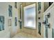 Modern shower with travertine tile, rainfall shower head, and stylish glass accents at 940 Monte Cristo Blvd, Tierra Verde, FL 33715