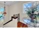 Elegant staircase features a mermaid stained glass window, hardwood floors, and designer accents at 940 Monte Cristo Blvd, Tierra Verde, FL 33715