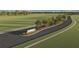 Community entrance with the Riverwood sign on a landscaped median in the road at 1076 Kistna Dr, Zephyrhills, FL 33540