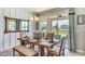 Open dining area with stylish chandelier, a large window, and sliding glass door access at 10817 Patoka Ter, Parrish, FL 34219