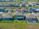 Aerial view of a community displaying landscaping, pools, and a manicured lawn at 11232 Bram Bay Ct, San Antonio, FL 33576