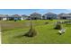 Lush green backyard with a gentle slope, mature landscaping and comfortable Adirondack chairs at 11232 Bram Bay Ct, San Antonio, FL 33576