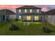 Backyard with lawn, trees, and covered patio seating area at 11232 Bram Bay Ct, San Antonio, FL 33576