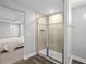 Bathroom featuring a glass-enclosed shower with tile surround and wood look flooring at 11232 Bram Bay Ct, San Antonio, FL 33576