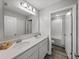Bright bathroom boasts a double vanity and a glimpse into the adjacent shower at 11232 Bram Bay Ct, San Antonio, FL 33576
