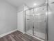 Bathroom featuring a glass-enclosed shower and a closet with folding doors at 11232 Bram Bay Ct, San Antonio, FL 33576
