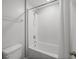 Bright white bathroom featuring a combination shower and tub with tiled walls at 11232 Bram Bay Ct, San Antonio, FL 33576