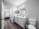 Bright bathroom boasts a modern vanity and a glimpse into the adjacent bedroom at 11232 Bram Bay Ct, San Antonio, FL 33576