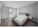 Bedroom featuring wood look floors, side tables, desk, and lots of natural light at 11232 Bram Bay Ct, San Antonio, FL 33576