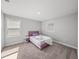 Bright bedroom with carpet flooring features a cozy bed and natural light at 11232 Bram Bay Ct, San Antonio, FL 33576