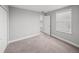 Neutral bedroom featuring a carpeted floor, closet, and large windows at 11232 Bram Bay Ct, San Antonio, FL 33576