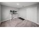 Carpeted bedroom featuring a walk-in closet, sit stand desk with monitor, and compact treadmill at 11232 Bram Bay Ct, San Antonio, FL 33576