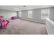Large bonus room offering neutral carpeting, three windows, and plenty of open floor space at 11232 Bram Bay Ct, San Antonio, FL 33576