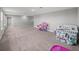Spacious bonus room with neutral carpet, ideal for a playroom or additional living area at 11232 Bram Bay Ct, San Antonio, FL 33576