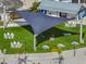 Aerial shot of a lawn area with picnic tables, outdoor games, and shade structures, perfect for community gatherings and relaxation at 11232 Bram Bay Ct, San Antonio, FL 33576