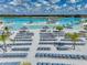 Beautiful community pool with lounge chairs, tiki huts, and a water park, offering endless summer fun at 11232 Bram Bay Ct, San Antonio, FL 33576