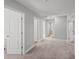 Hallway shows multiple doorways and neutral-colored carpeting at 11232 Bram Bay Ct, San Antonio, FL 33576
