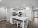 Bright kitchen featuring a center island with seating, white cabinets, and stainless steel appliances at 11232 Bram Bay Ct, San Antonio, FL 33576