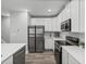 Modern kitchen featuring stainless steel appliances, white cabinets, and a subway tile backsplash at 11232 Bram Bay Ct, San Antonio, FL 33576