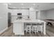 Bright kitchen featuring a center island with seating, white cabinets, and stainless steel appliances at 11232 Bram Bay Ct, San Antonio, FL 33576