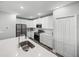 Modern kitchen featuring white cabinets, quartz countertops, stainless steel appliances, and a center island at 11232 Bram Bay Ct, San Antonio, FL 33576