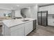 Bright kitchen featuring a center island, stainless steel appliances, and seamless connection to living area at 11232 Bram Bay Ct, San Antonio, FL 33576