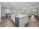 Open-concept living space with a large island, stainless steel appliances, and billiard table for recreation at 11232 Bram Bay Ct, San Antonio, FL 33576