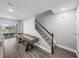 Well-lit living room featuring hardwood floors, a pool table, staircase, and sliding glass doors to the backyard at 11232 Bram Bay Ct, San Antonio, FL 33576
