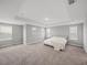 Serene main bedroom with neutral carpet, recessed lighting, and large windows at 11232 Bram Bay Ct, San Antonio, FL 33576