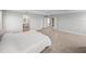 Open main bedroom leading to the ensuite bathroom, with neutral carpet and a modern design at 11232 Bram Bay Ct, San Antonio, FL 33576