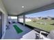 A screened-in patio with lawn chairs overlooks the fenced backyard at 11232 Bram Bay Ct, San Antonio, FL 33576