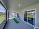 Covered screened patio with a mini golf setup, seating, and sliding glass doors at 11232 Bram Bay Ct, San Antonio, FL 33576