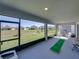 Screened-in patio with an outdoor golf setup and backyard views at 11232 Bram Bay Ct, San Antonio, FL 33576