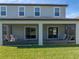 The backyard's screened patio has outdoor seating with a green lawn beyond at 11232 Bram Bay Ct, San Antonio, FL 33576
