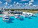 Aerial view of pool featuring floating cabana loungers, umbrellas, and ample seating for relaxation and entertainment at 11232 Bram Bay Ct, San Antonio, FL 33576