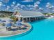 Expansive poolside bar area with ample seating, tables with umbrellas, and a swim-up bar, perfect for relaxing and entertaining at 11232 Bram Bay Ct, San Antonio, FL 33576