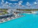 Aerial view of a pool with lounge seating, cabanas, umbrellas, and clear blue water, perfect for relaxation and outdoor enjoyment at 11232 Bram Bay Ct, San Antonio, FL 33576