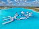 Aerial view of a water park featuring clear turquoise water and inflatable water structure at 11232 Bram Bay Ct, San Antonio, FL 33576