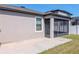 View of backyard, patio, and enclosed screened patio with view of grassy yard at 11407 Amapola Bloom Ct, Riverview, FL 33579